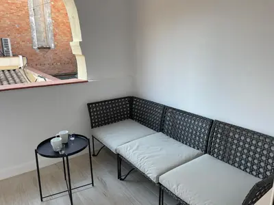 two benches in a room with a table and a window at Apartamentos Barcelona - Iberia in Barcelona