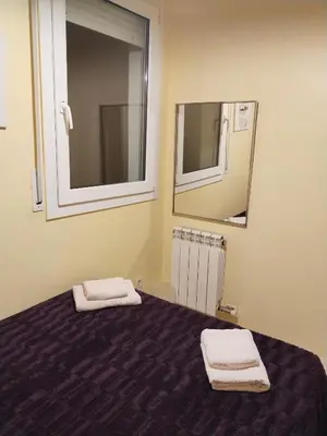 a bedroom with a bed with two towels on it at Apartament Fira in Hospitalet de Llobregat