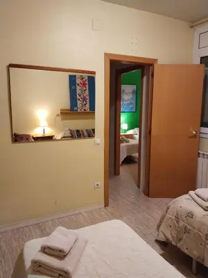 a room with a bedroom with a mirror and a bed at Apartament Fira in Hospitalet de Llobregat