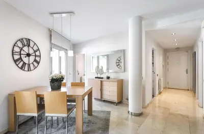 a dining room with a table and a clock on the wall at TARRACO - Private Pool Villa in Arenys de Munt in Arenys de Munt