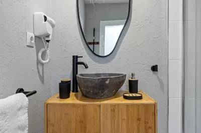 a bathroom with a sink and a mirror at Hauzify I Casa Olivella A in Olivella