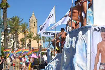 a group of naked people on a billboard at a beach at Francesc Macià, Sitges in Sitges