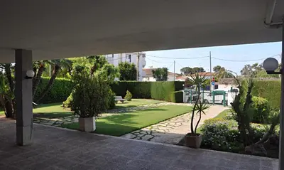 a view of a garden with trees and plants at Apartamento Mallorca, muy cerca de la playa in Sitges