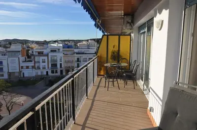a balcony with chairs and a table on it at Santa Barbara, in downtown Sitges in Sitges
