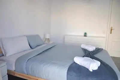 a bedroom with a bed with towels on it at Santa Barbara, in downtown Sitges in Sitges