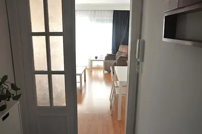 a living room with a door open to a living room at Santa Barbara, in downtown Sitges in Sitges