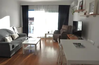 a living room with a couch and a table at Santa Barbara, in downtown Sitges in Sitges