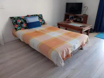 a bedroom with a large bed and a table at Apartamento 2º centrico con Parking en Calella,Barcelona in Calella