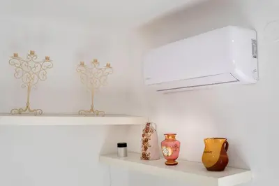 a white kitchen with vases sitting on shelves at Apartamento 2º centrico con Parking en Calella,Barcelona in Calella