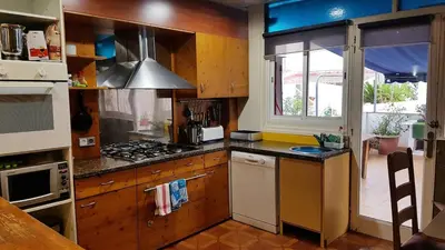 a kitchen with a stove top oven next to a window at Apart 1º & Spa and Parking in Calella, Barcelona in Calella