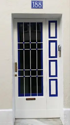 a white and blue door with a sign on it at Apart 1º & Spa and Parking in Calella, Barcelona in Calella