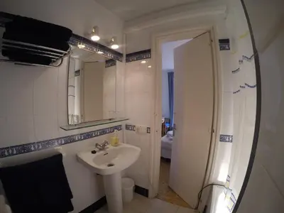 a bathroom with a sink and a mirror at Apartamentos Montserrat in Sitges
