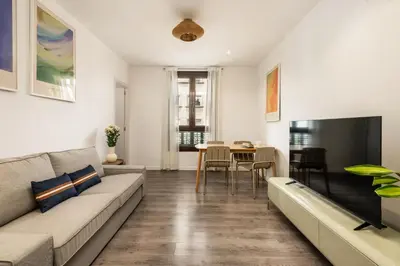 a living room with a couch and a table at Eixample Pedestrian Gem Balcony Bathtub AC in Barcelona