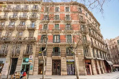 a large brick building on a city street at Eixample Pedestrian Gem Balcony Bathtub AC in Barcelona