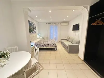 a living room with a couch and a table at Rooms Consell de Cent in Barcelona