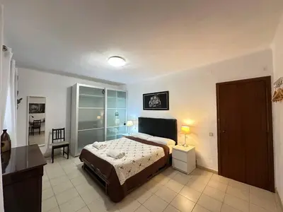 a bedroom with a bed and a desk in it at Rooms Consell de Cent in Barcelona