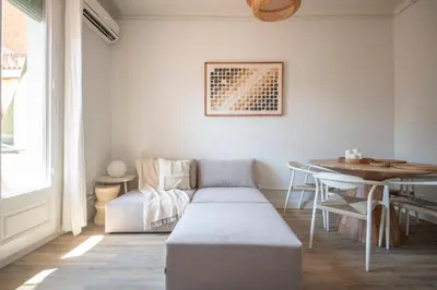 a living room with a couch and a table at You Stylish Eixample Apartments in Barcelona