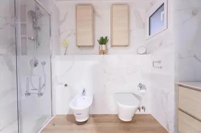 a bathroom with a toilet and a sink and a shower at ApartEasy mid-term ONLY for VACATIONS stays, EIXAMPLE CENTER in Barcelona