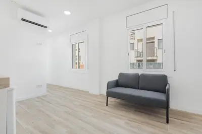 a chair in an empty room with white walls at Apartahotel Sant Marti Suites in San Martín Sarroca