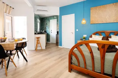 a white bedroom with a large bed and two windows at 2A - Studio for 2 in Sant Adria de Besos