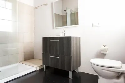 a bathroom with a sink and a toilet and a mirror at ApartEasy mid-term ONLY for VACATIONS stays, ATIC GRACIA in Barcelona