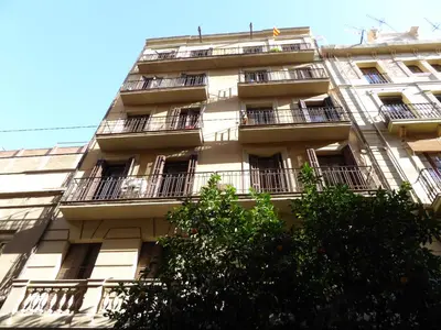 a tall building with balconies on the side of it at ApartEasy mid-term ONLY for VACATIONS stays, ATIC GRACIA in Barcelona