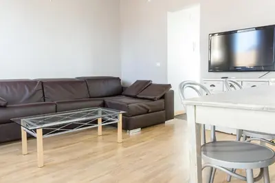 a living room with a couch and a table at ApartEasy mid-term ONLY for VACATIONS stays, ATIC GRACIA in Barcelona
