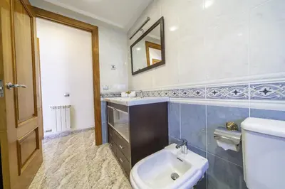 a bathroom with a sink and a toilet and a mirror at HomeHolidaysRentals Coquette - Costa Barcelona in Pineda de Mar