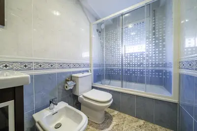 a bathroom with a toilet and a sink and a shower at HomeHolidaysRentals Coquette - Costa Barcelona in Pineda de Mar