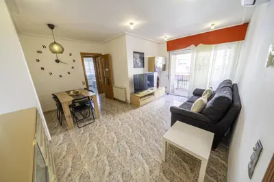 a living room with a couch and a table at HomeHolidaysRentals Coquette - Costa Barcelona in Pineda de Mar