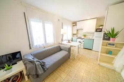 a white kitchen with a refrigerator and a sink at HomeHolidaysRentals Olimpia - Costa Barcelona in Pineda de Mar