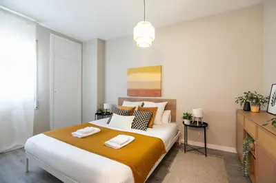 a bedroom with a large bed with two towels on it at Eixample Barcelona Luxury for 8 in Barcelona