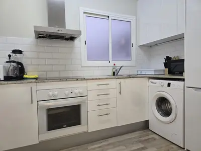 a bedroom with a large bed and a window at little 3 bedrooms apartement barcelona center in Barcelona