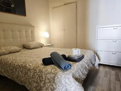 a bedroom with a bed with a nightstand and a bed sidx sidx sidx sidx at little 3 bedrooms apartement barcelona center in Barcelona