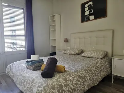 a living room with a blue couch and two pictures on the wall at little 3 bedrooms apartement barcelona center in Barcelona
