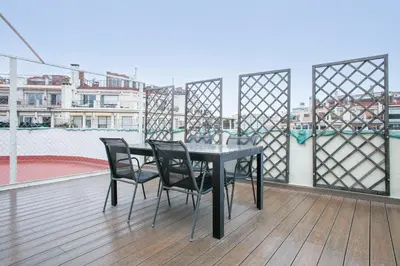 a black table and chairs on a balcony at Alcam Entenza in Barcelona