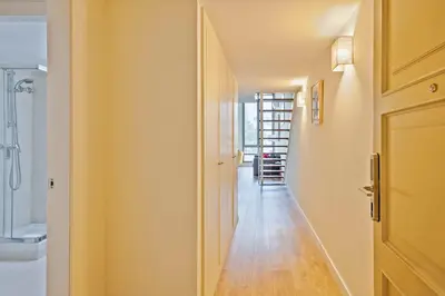 a hallway with a door to a bathroom with a toilet at Alcam Paseo de Gracia in Barcelona