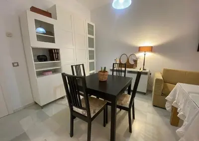 a dining room with a table and chairs and a couch at Cristina in Arenys de Mar