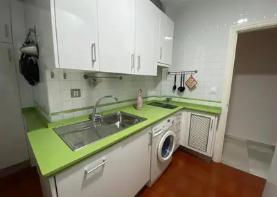 a kitchen with a sink and a washing machine at Cristina in Arenys de Mar