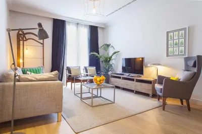 a living room with a couch and a tv at Ola Living Broto in Barcelona