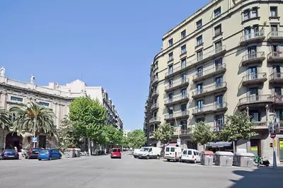 a city street with cars parked in front of a building at Bcncaliu in Barcelona