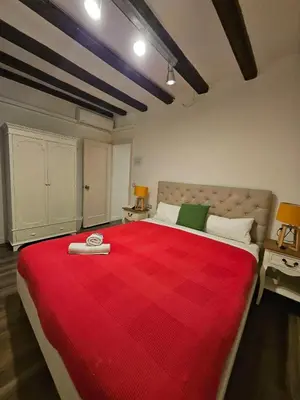 a bedroom with a large bed with a red blanket at Five Room Family Flat Near Ramblas in Barcelona