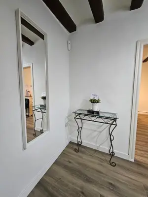 a room with a glass table and a mirror at Five Room Family Flat Near Ramblas in Barcelona
