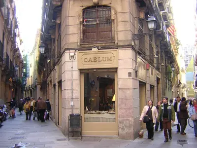 a group of people walking down a street in front of a store at Five Room Family Flat Near Ramblas in Barcelona
