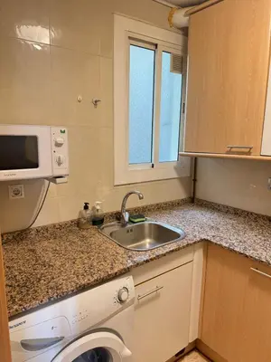 a small kitchen with a sink and a microwave at NEW! Apartment for 4 people near the beach in Poblenou in Barcelona