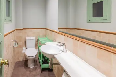 a bathroom with a toilet and a sink and a tub at Modernist Apartment 2 in Barcelona