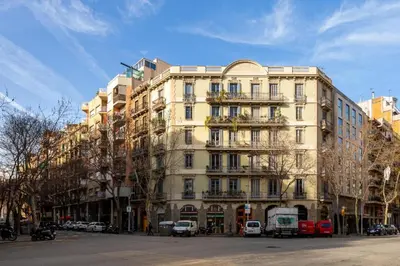 a large white building on a city street with cars at Modernist Apartment 2 in Barcelona