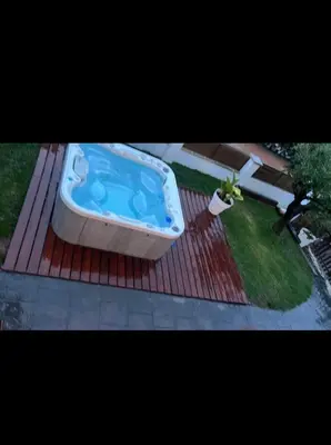 a bath tub sitting on top of a deck at Apartamento colibrí in Sitges