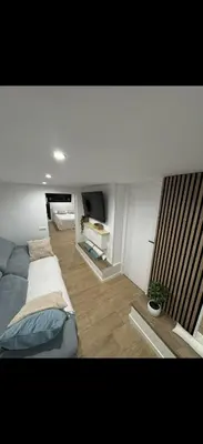 a flat screen tv sitting on top of a white wall at Apartamento colibrí in Sitges