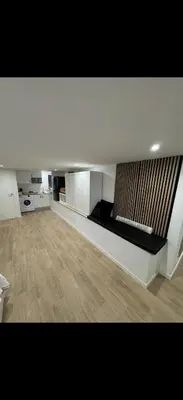 a small living room with a couch and a tv at Apartamento colibrí in Sitges